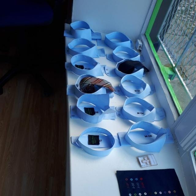 Selection of bespoke shirt collar samples displayed at Alberto Ricci Tailoring workshop.