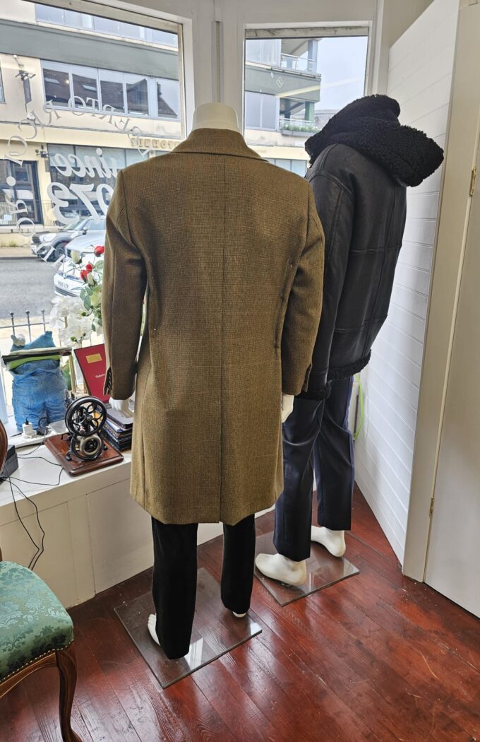 “Two bespoke overcoats displayed on mannequins at Alberto Ricci Tailoring in Forres, showcasing handcrafted Scottish tailoring and classic wool designs.