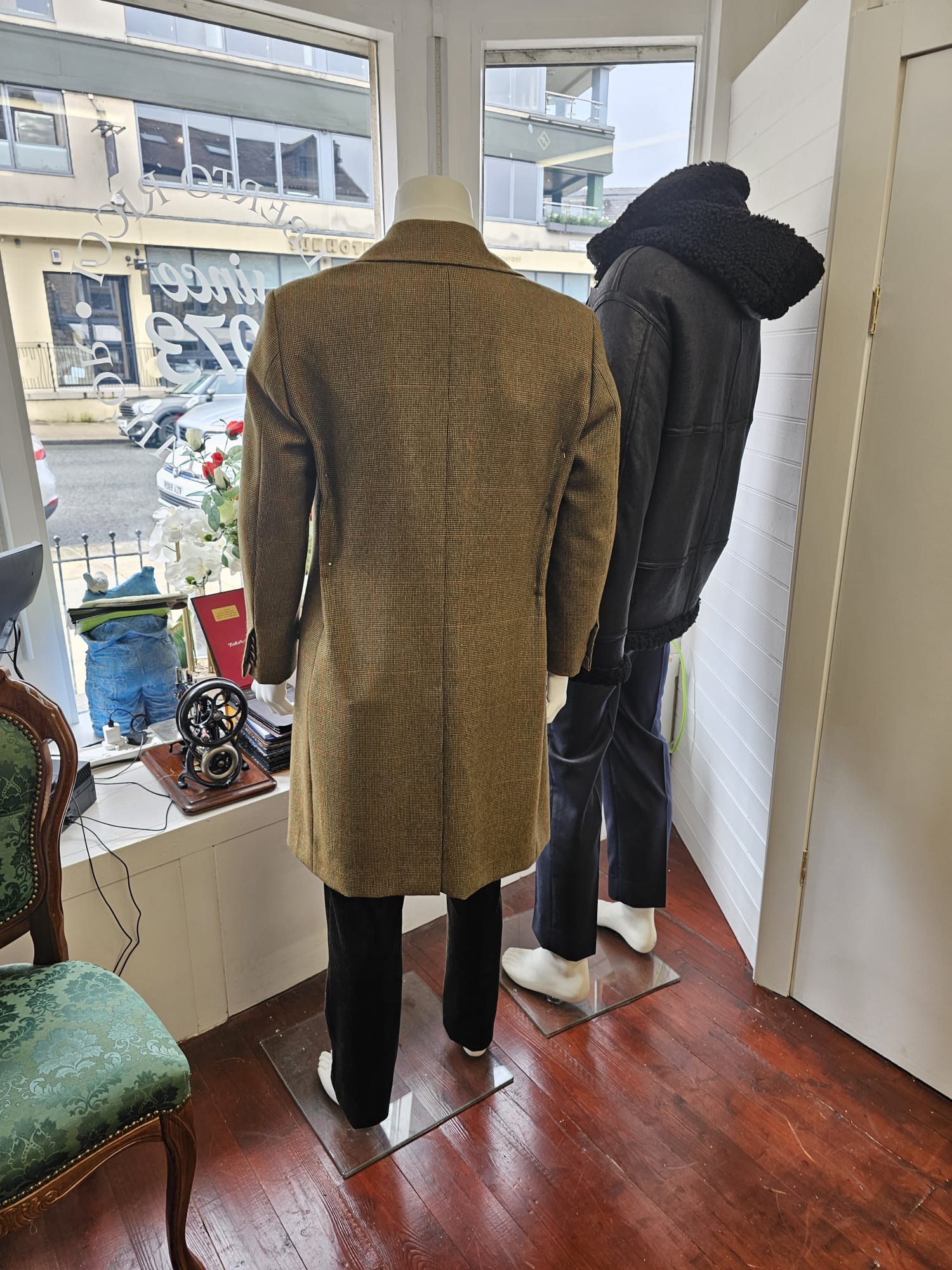 “Two bespoke overcoats displayed on mannequins at Alberto Ricci Tailoring in Forres, showcasing handcrafted Scottish tailoring and classic wool designs.